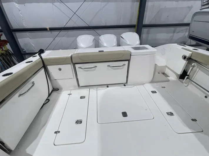 Sea Hawk Yacht Photos Pics 2020 Pursuit OS 355 Offshore boat deck with storage compartments and seating.