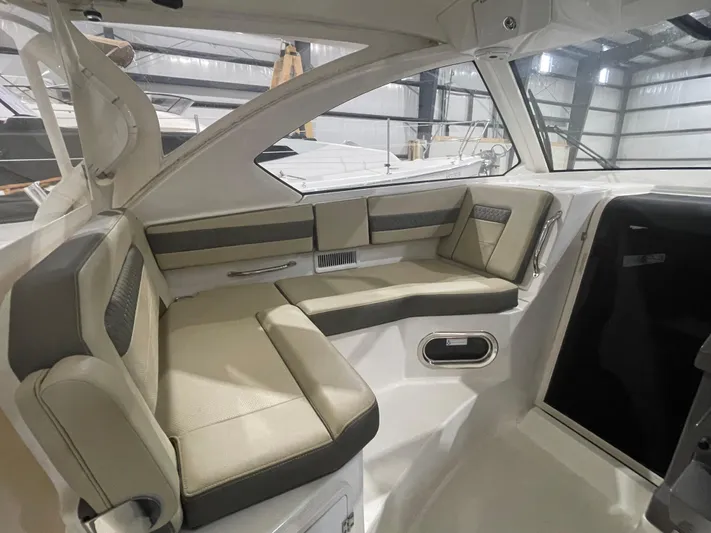 Sea Hawk Yacht Photos Pics 2020 Pursuit OS 355 Offshore boat interior with beige seating in a spacious cabin.