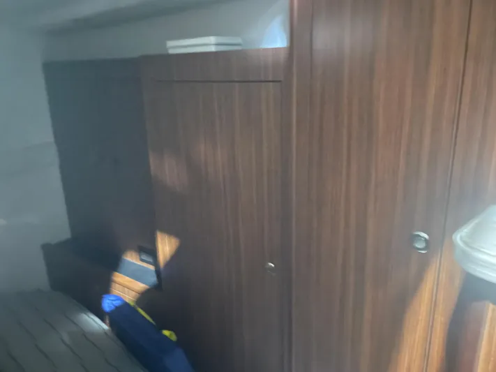 Sea Hawk Yacht Photos Pics 2020 Pursuit OS 355 Offshore cabin interior with wooden cabinetry and seating.