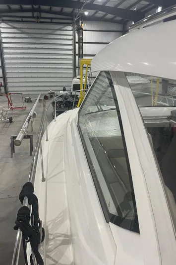 Sea Hawk Yacht Photos Pics 2020 Pursuit OS 355 Offshore boat in a storage facility.