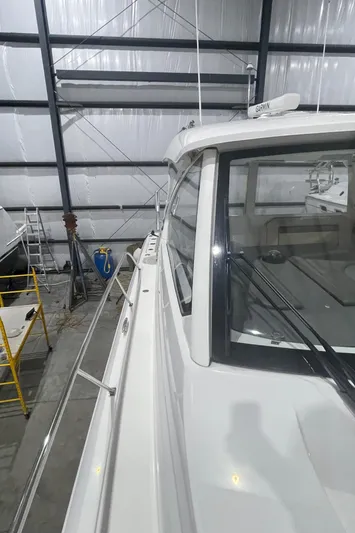 Sea Hawk Yacht Photos Pics 2020 Pursuit OS 355 Offshore boat in a storage facility.