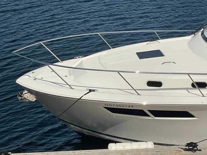 Sea Hawk Yacht Photos Pics 2020 Pursuit OS 355 Offshore boat docked on calm blue water.
