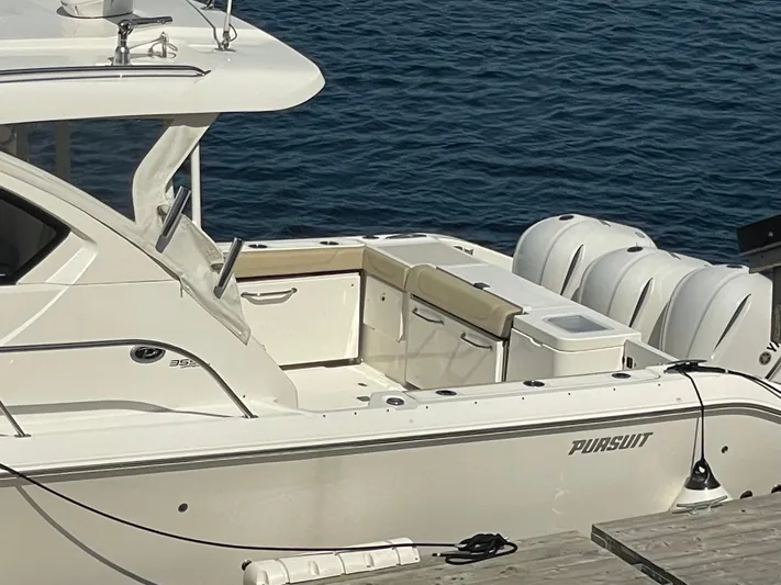 Sea Hawk Yacht Photos Pics 2020 Pursuit OS 355 Offshore boat docked by the water.