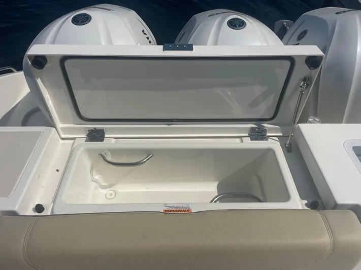 Sea Hawk Yacht Photos Pics 2020 Pursuit OS 355 Offshore boat with open storage compartment and visible outboard engines.