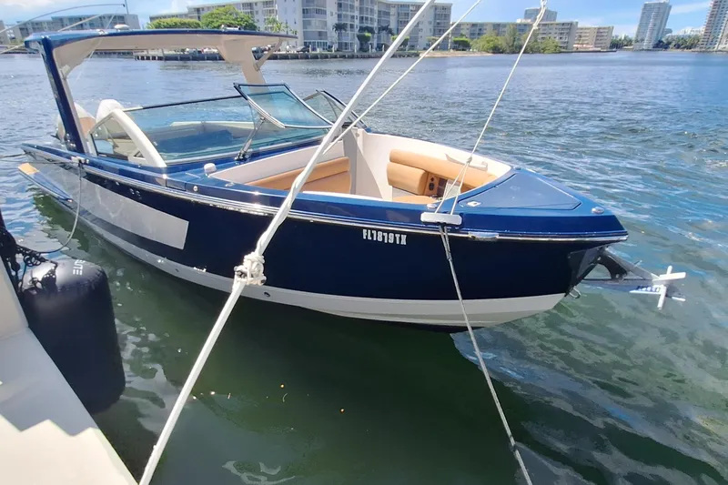  Yacht Photos Pics 2021 Aviara AV32 OB boat docked on calm water, modern design, blue and white exterior.