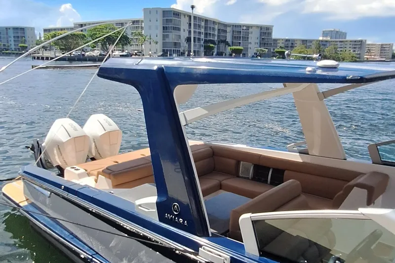  Yacht Photos Pics 2021 Aviara AV32 OB luxury boat docked near waterfront buildings.