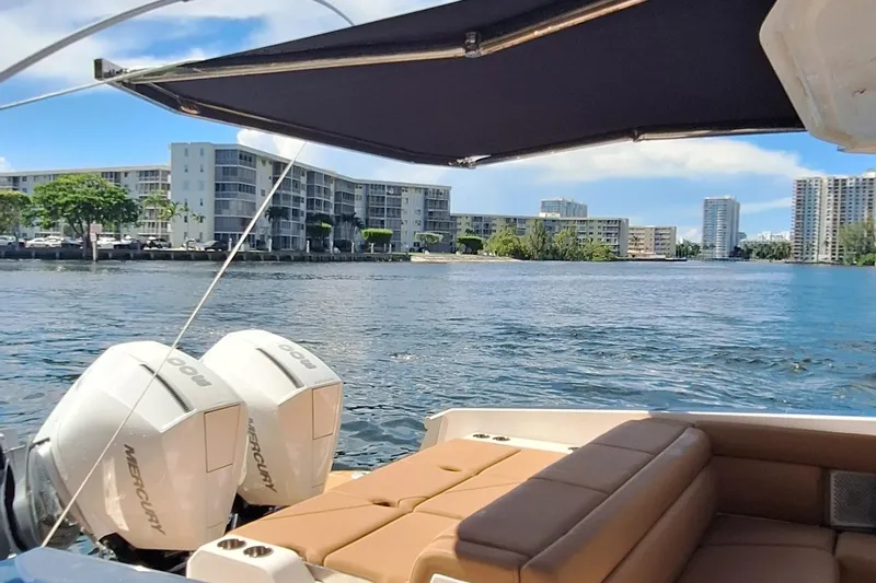  Yacht Photos Pics 2021 Aviara AV32 OB boat with twin Mercury engines on a scenic waterfront.