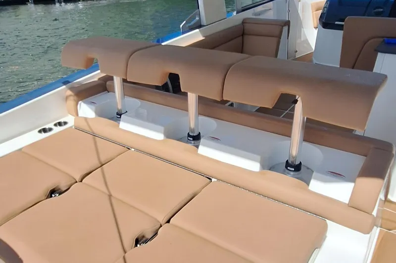  Yacht Photos Pics 2021 Aviara AV32 OB boat with tan seating and adjustable backrests on the water.