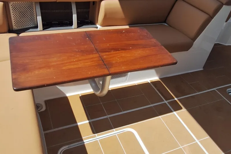  Yacht Photos Pics 2021 Aviara AV32 OB boat interior with wooden table and cushioned seating.