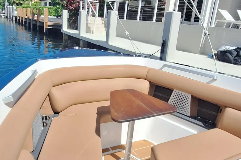  Yacht Photos Pics Luxurious seating area on 2021 Aviara AV32 OB boat with wooden table.