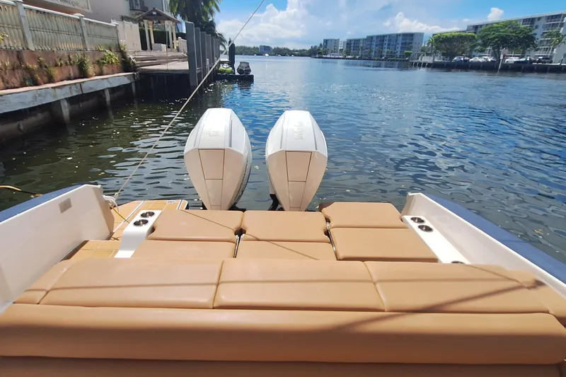  Yacht Photos Pics 2021 Aviara AV32 OB boat with twin outboard engines on a sunny waterfront.