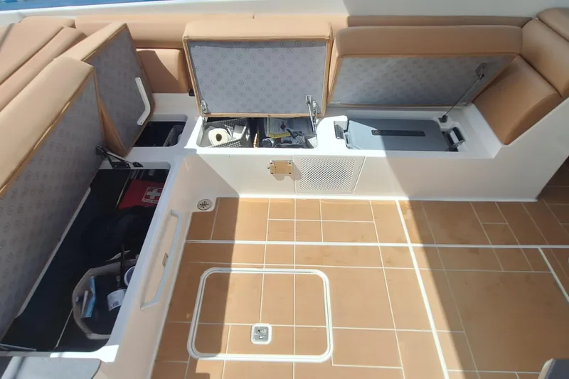  Yacht Photos Pics 2021 Aviara AV32 OB boat interior storage compartments with tan seating and teak flooring.