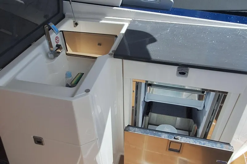  Yacht Photos Pics 2021 Aviara AV32 OB boat kitchenette with sink and storage compartments.