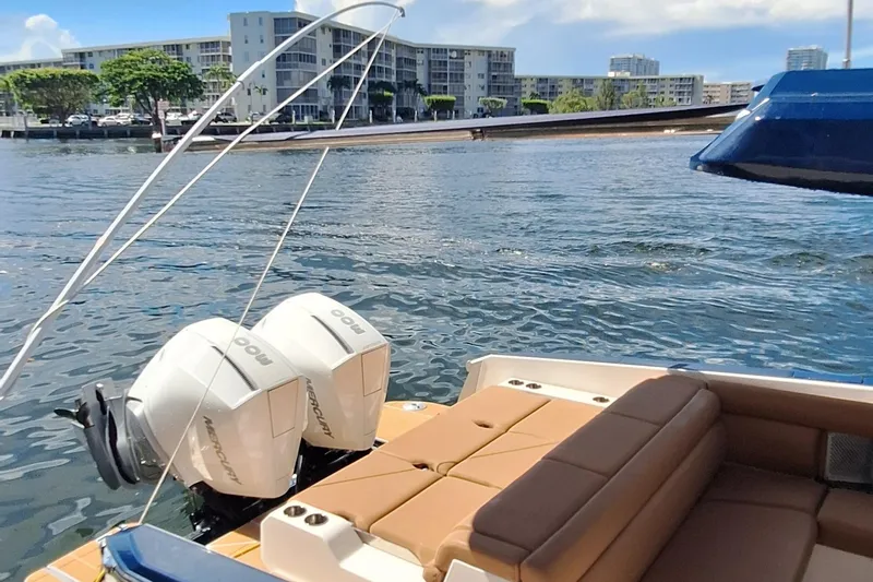  Yacht Photos Pics 2021 Aviara AV32 OB boat with twin Mercury outboard engines on a sunny waterfront.