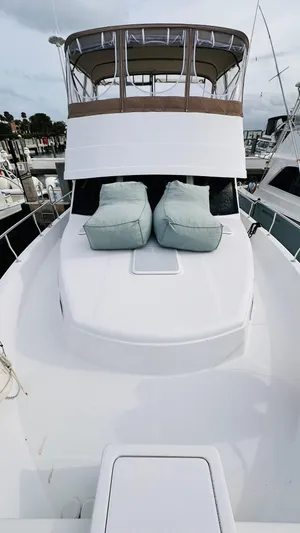 Jomallie Yacht Photos Pics 1999 Mainship 430 Trawler with cushioned deck, docked at marina.