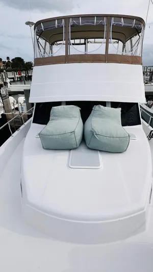 Jomallie Yacht Photos Pics 1999 Mainship 430 Trawler with cushioned deck seating, docked at a marina.