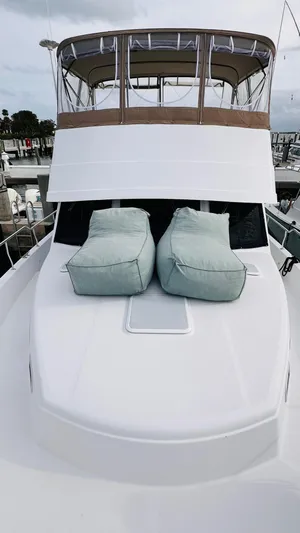 Jomallie Yacht Photos Pics 1999 Mainship 430 Trawler with cushioned deck seating, docked at a marina.