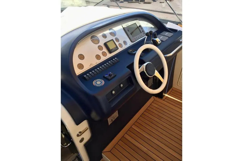  Yacht Photos Pics Helm of 2008 Cantieri di Sarnico 43 yacht with steering wheel and control panel.