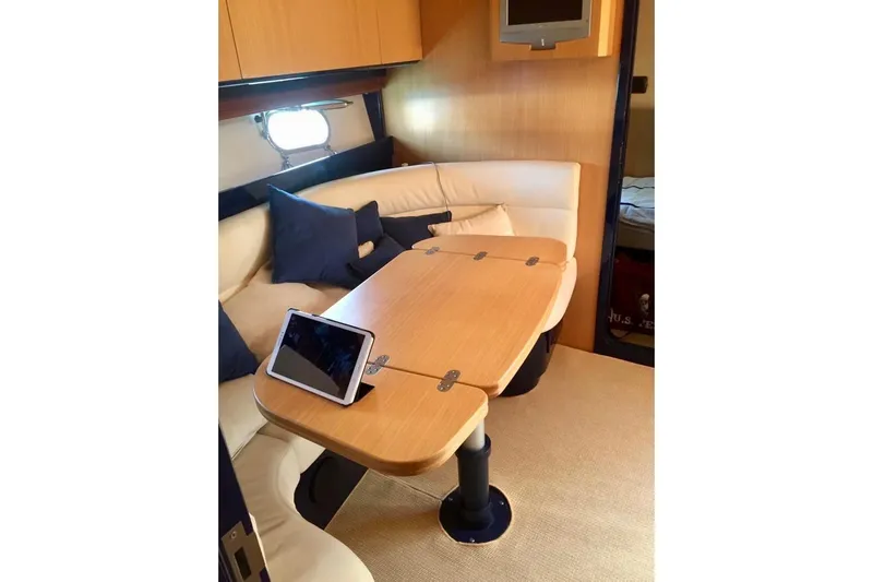  Yacht Photos Pics Luxurious interior of 2008 Cantieri di Sarnico 43 yacht with cozy seating and table.