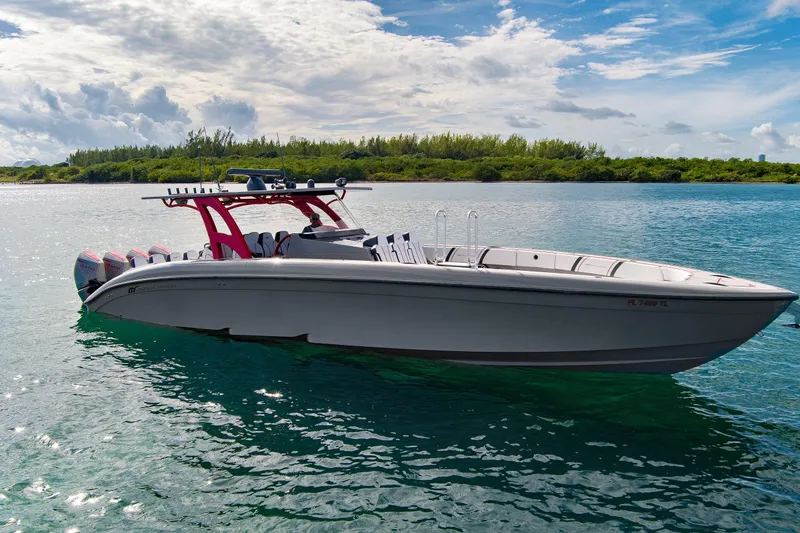  Yacht Photos Pics 2023 Midnight Express 43 Open boat on calm water under a partly cloudy sky.