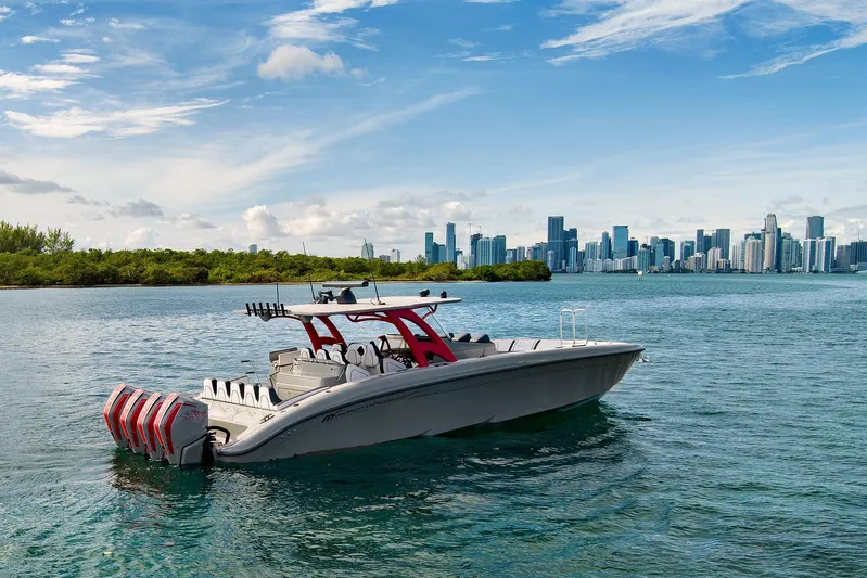  Yacht Photos Pics 2023 Midnight Express 43 Open boat on water with city skyline background.