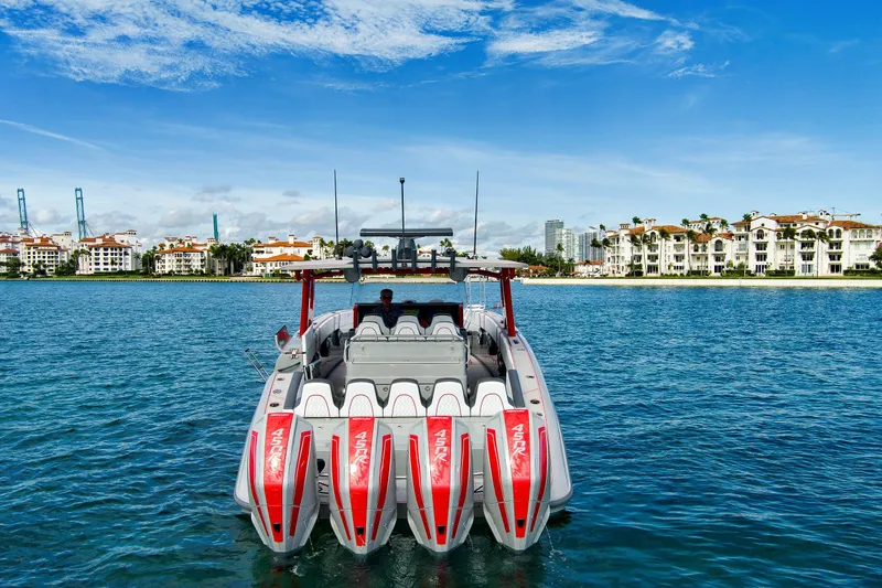  Yacht Photos Pics 2023 Midnight Express 43 Open boat on water with scenic coastal backdrop.