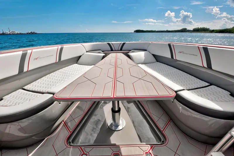  Yacht Photos Pics Luxurious 2023 Midnight Express 43 Open boat interior with sleek seating and table, ocean backdrop.