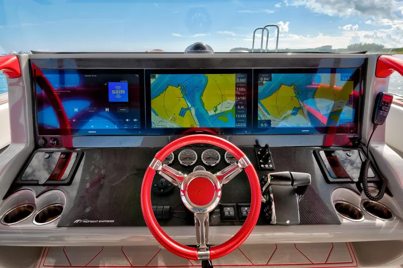  Yacht Photos Pics 2023 Midnight Express 43 Open dashboard with navigation screens and red steering wheel.