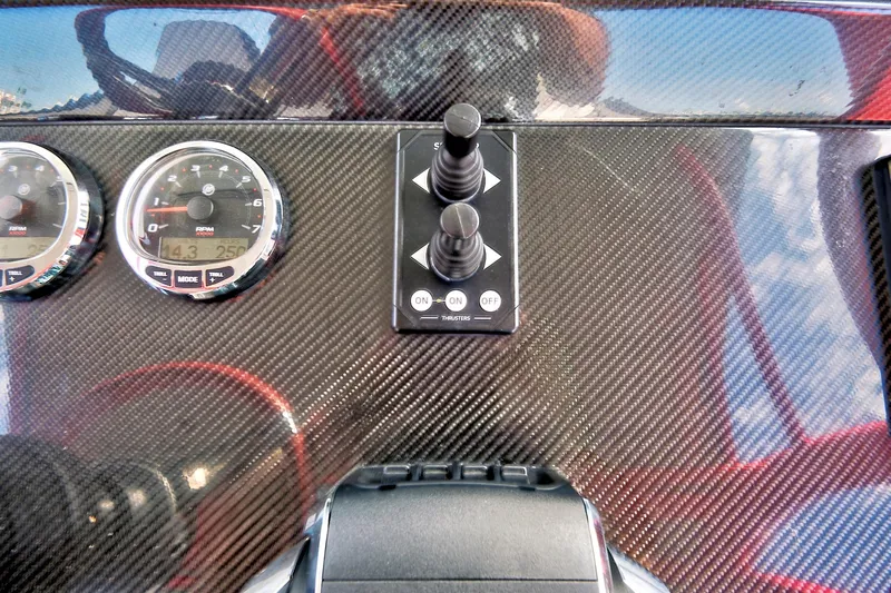  Yacht Photos Pics Carbon fiber dashboard of 2023 Midnight Express 43 Open with gauges and controls.