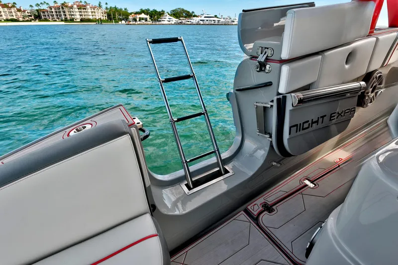  Yacht Photos Pics 2023 Midnight Express 43 Open boat with ladder, docked by clear blue water.