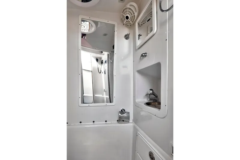  Yacht Photos Pics Bathroom interior of 2023 Midnight Express 43 Open boat, featuring mirror and sink.