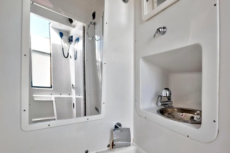  Yacht Photos Pics Interior of 2023 Midnight Express 43 Open boat bathroom with sink and mirror.