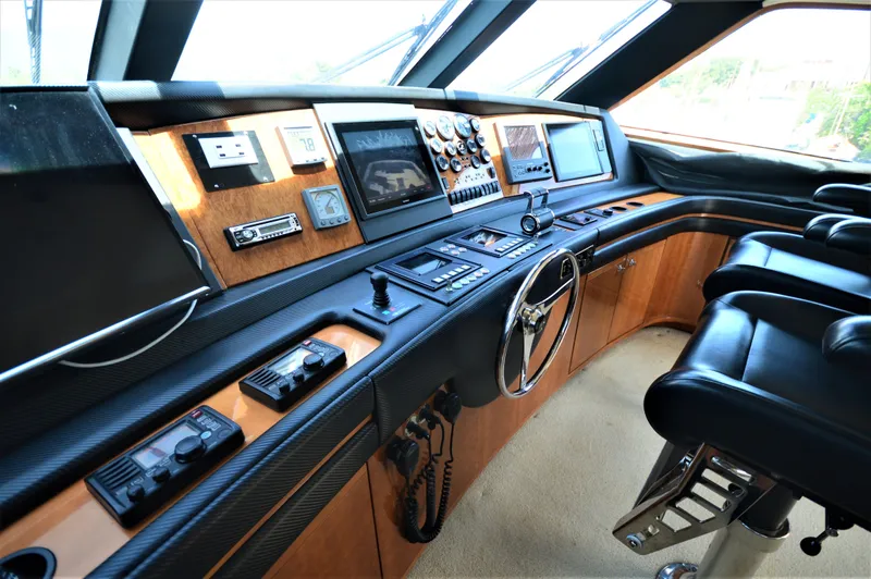 Gabby Millan 2 Yacht Photos Pics 2003 Bertram 67 Convertible yacht helm with advanced navigation systems and leather seating.