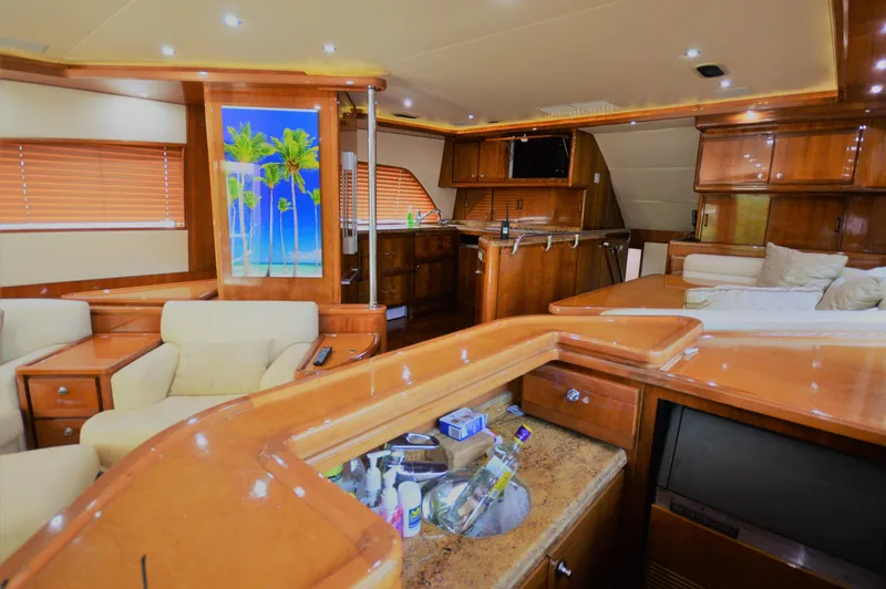 Gabby Millan 2 Yacht Photos Pics Luxurious interior of a 2003 Bertram 67 Convertible yacht with wooden finishes.