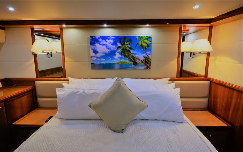 Gabby Millan 2 Yacht Photos Pics Luxurious bedroom interior of 2003 Bertram 67 Convertible yacht with tropical wall art.