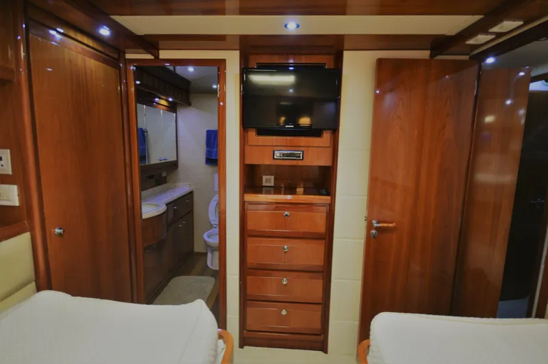 Gabby Millan 2 Yacht Photos Pics Interior of 2003 Bertram 67 Convertible yacht with wooden cabinetry and ensuite bathroom.
