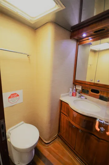 Gabby Millan 2 Yacht Photos Pics Bathroom interior of a 2003 Bertram 67 Convertible yacht with wooden cabinetry.