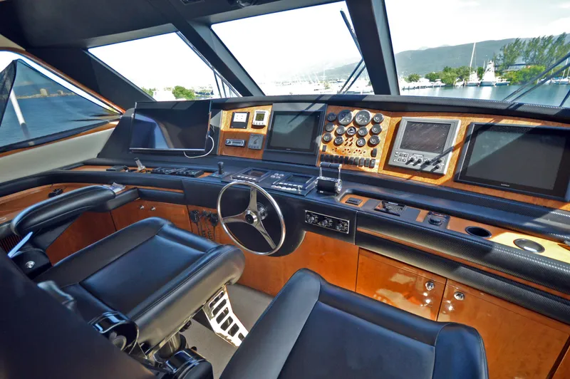 Gabby Millan 2 Yacht Photos Pics Cockpit of a 2003 Bertram 67 Convertible yacht with modern navigation equipment.
