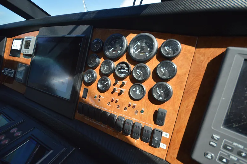 Gabby Millan 2 Yacht Photos Pics Dashboard of a 2003 Bertram 67 Convertible yacht with gauges and controls.