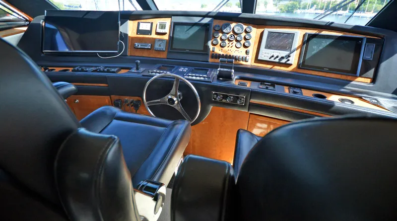 Gabby Millan 2 Yacht Photos Pics Interior helm of a 2003 Bertram 67 Convertible yacht with advanced navigation equipment.