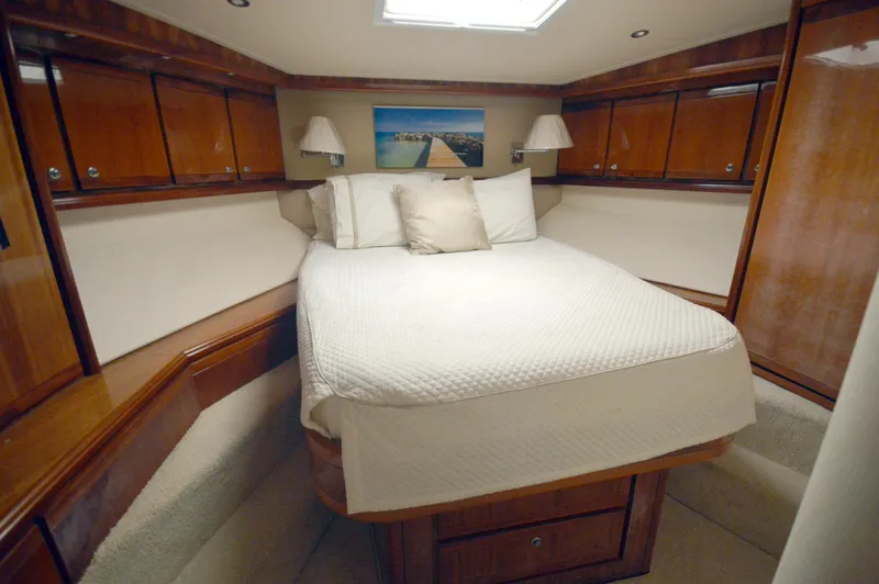 Gabby Millan 2 Yacht Photos Pics Luxurious bedroom in a 2003 Bertram 67 Convertible yacht with wooden cabinetry.