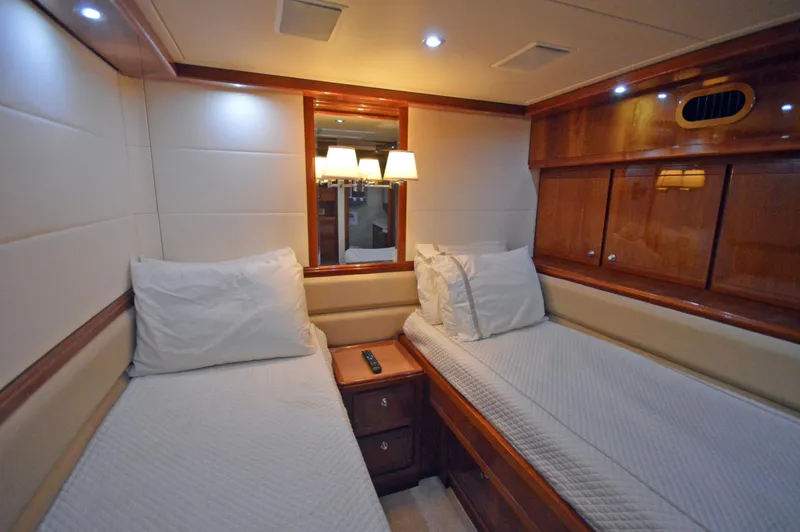 Gabby Millan 2 Yacht Photos Pics 2003 Bertram 67 Convertible yacht twin bed cabin with wooden furnishings.
