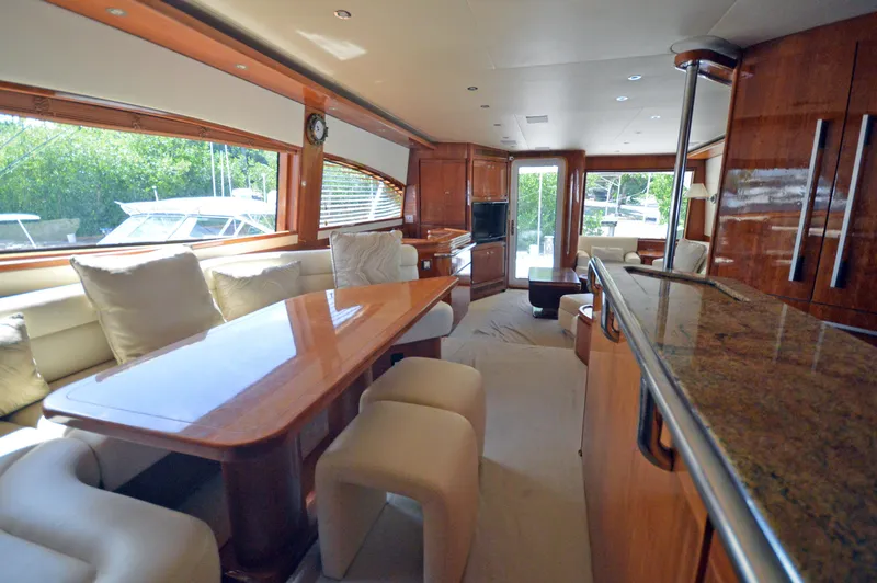 Gabby Millan 2 Yacht Photos Pics Luxurious interior of a 2003 Bertram 67 Convertible yacht with modern furnishings.