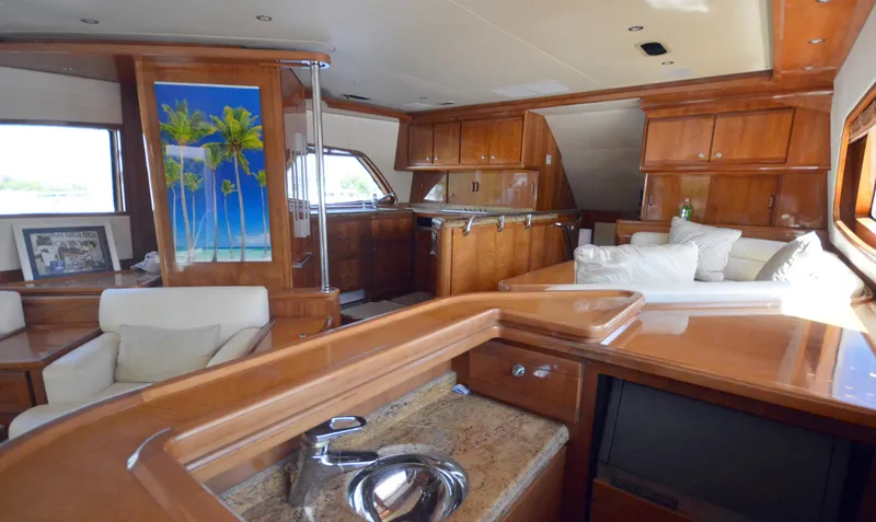 Gabby Millan 2 Yacht Photos Pics Luxurious interior of a 2003 Bertram 67 Convertible yacht with wooden finishes.