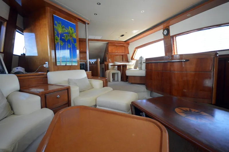 Gabby Millan 2 Yacht Photos Pics Luxurious interior of 2003 Bertram 67 Convertible yacht with wooden finishes and plush seating.
