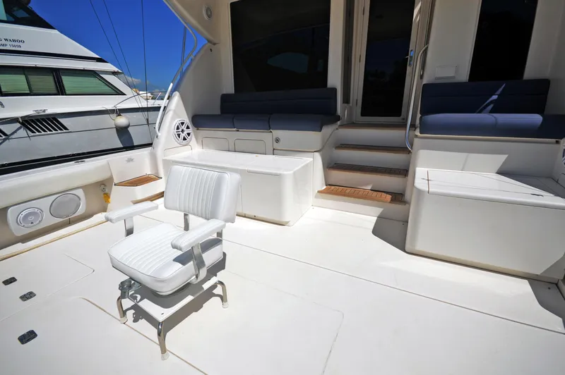 Gabby Millan 2 Yacht Photos Pics 2003 Bertram 67 Convertible yacht deck with seating and fishing chair.
