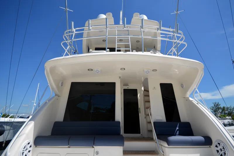 Gabby Millan 2 Yacht Photos Pics 2003 Bertram 67 Convertible yacht rear view with seating and upper deck.