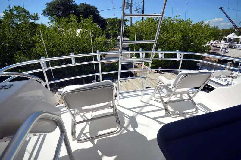 Gabby Millan 2 Yacht Photos Pics Upper deck of a 2003 Bertram 67 Convertible yacht with seating and railing.