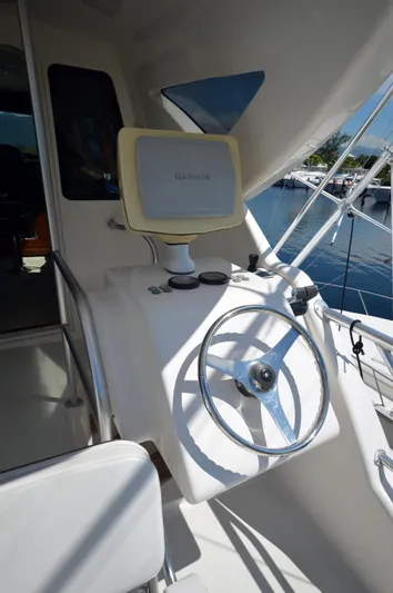 Gabby Millan 2 Yacht Photos Pics Steering console of a 2003 Bertram 67 Convertible yacht with Garmin navigation.