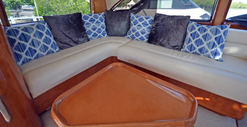Gabby Millan 2 Yacht Photos Pics Luxurious interior seating of a 2003 Bertram 67 Convertible yacht with plush cushions.